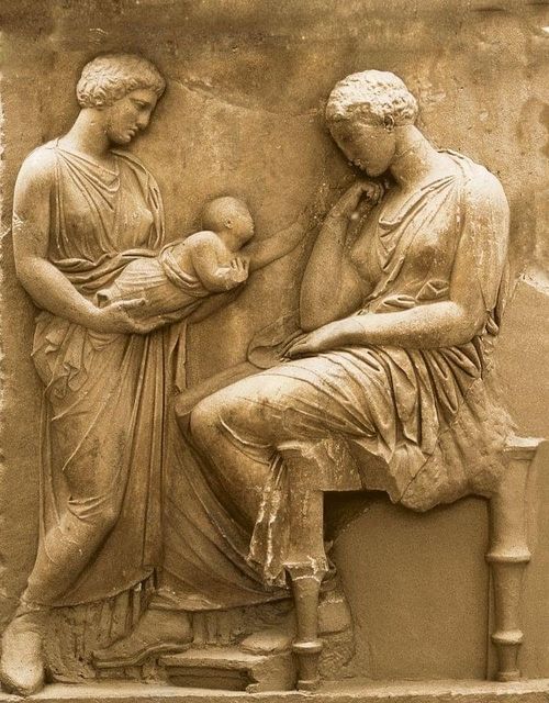 On this grave stele, you can see an Athenian young dead mother seated on a stool looking unemotionally at her son that is held by another standing woman.
