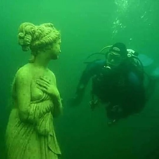 A diver meets a Greek statue at the sunken city of Heracleion near the coast of Alexandria in Egypt.