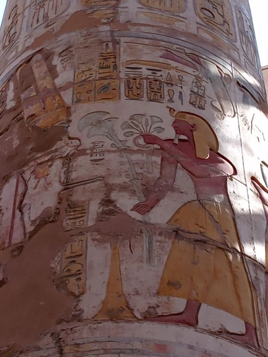 Ramses II offerings Lotus and Papyrus to Amon Min.