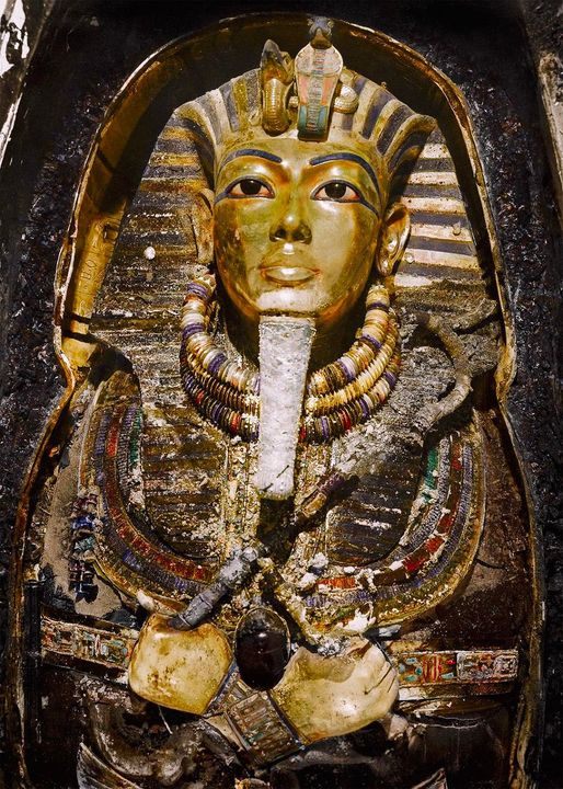 Harry Burton’s colourised photo of the death mask of Tutankhamun as seen by Howard Carter when he opened the inner golden coffin.